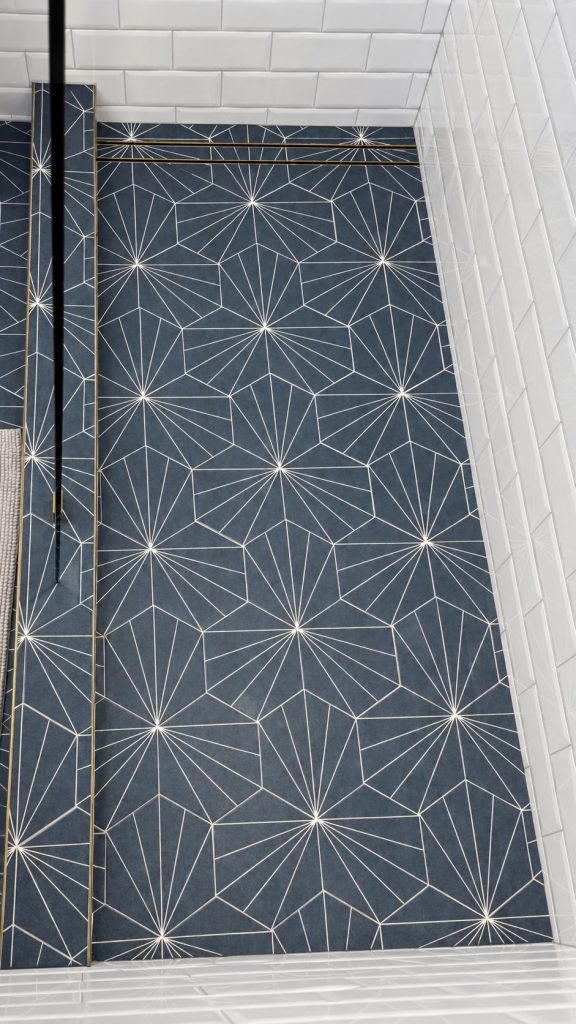 Blue geometric shower floor with brass drain