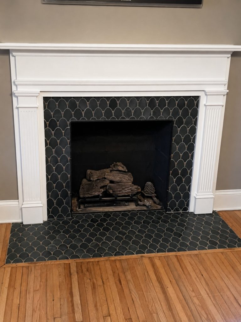 Refined charcoal tile fireplace and hearth