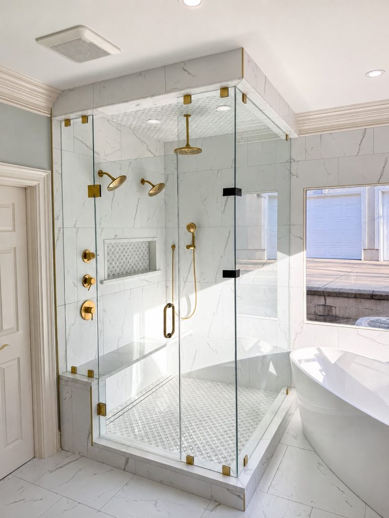 Sunlit Marble Bathroom with Brass Fixtures