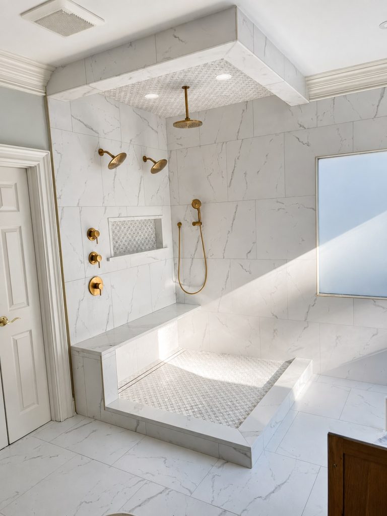 Sunlit Marble Shower with Brass Fixtures